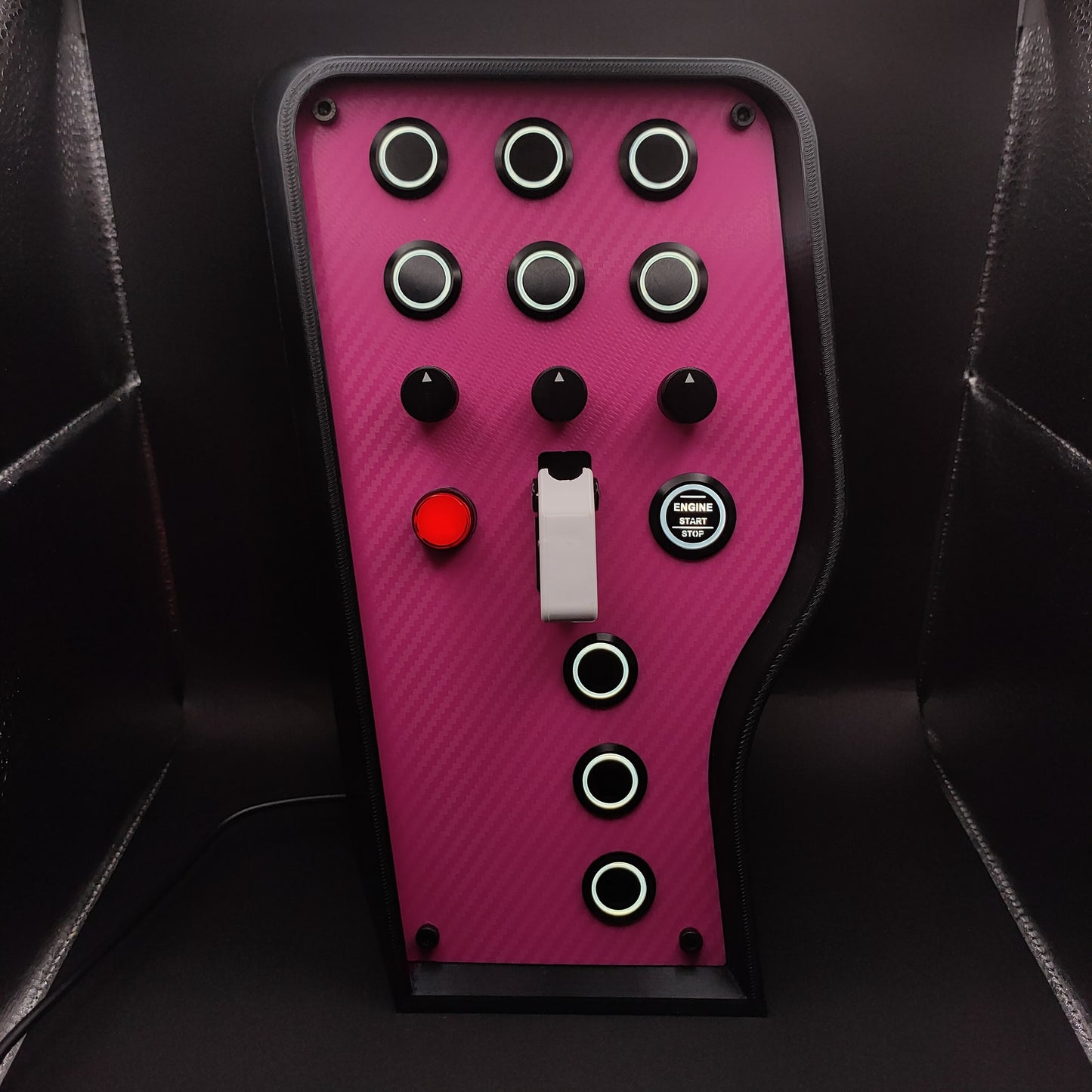 Pink Edition sim racing box featuring pink carbon fibre faceplate and high-contrast white toggle cover.