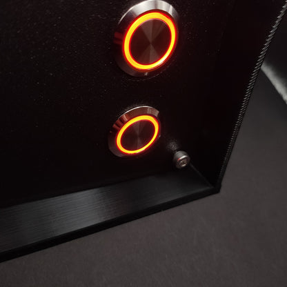 Detail shot showing the contrast between the premium chrome button housings with red LEDs and the rugged, non-reflective matte front panel.