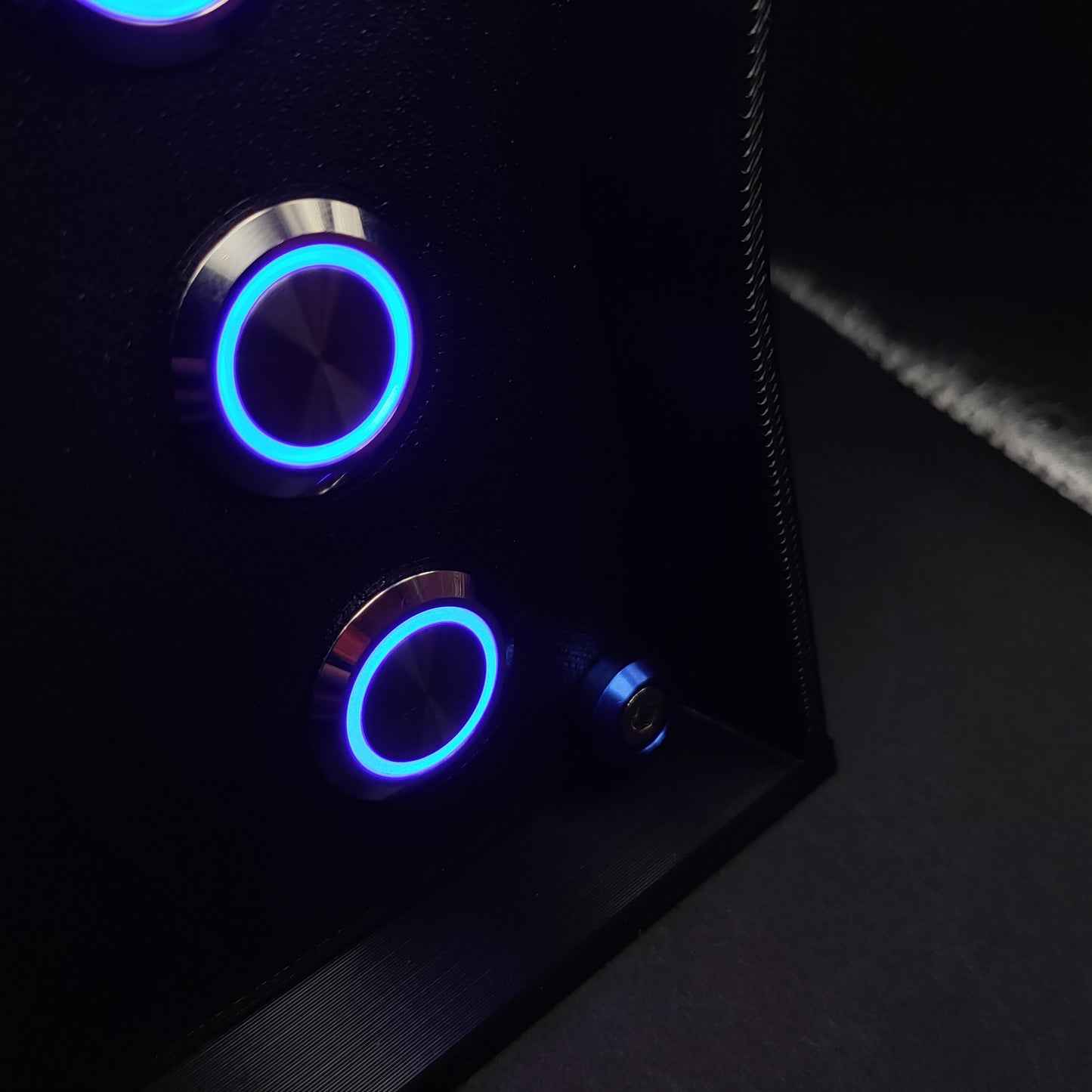 Detail shot of the chrome buttons with blue LEDs and the matching blue anodised aluminium hardware.