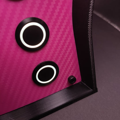 Detail shot of the unique pink carbon fibre faceplate and contrasting black hardware.