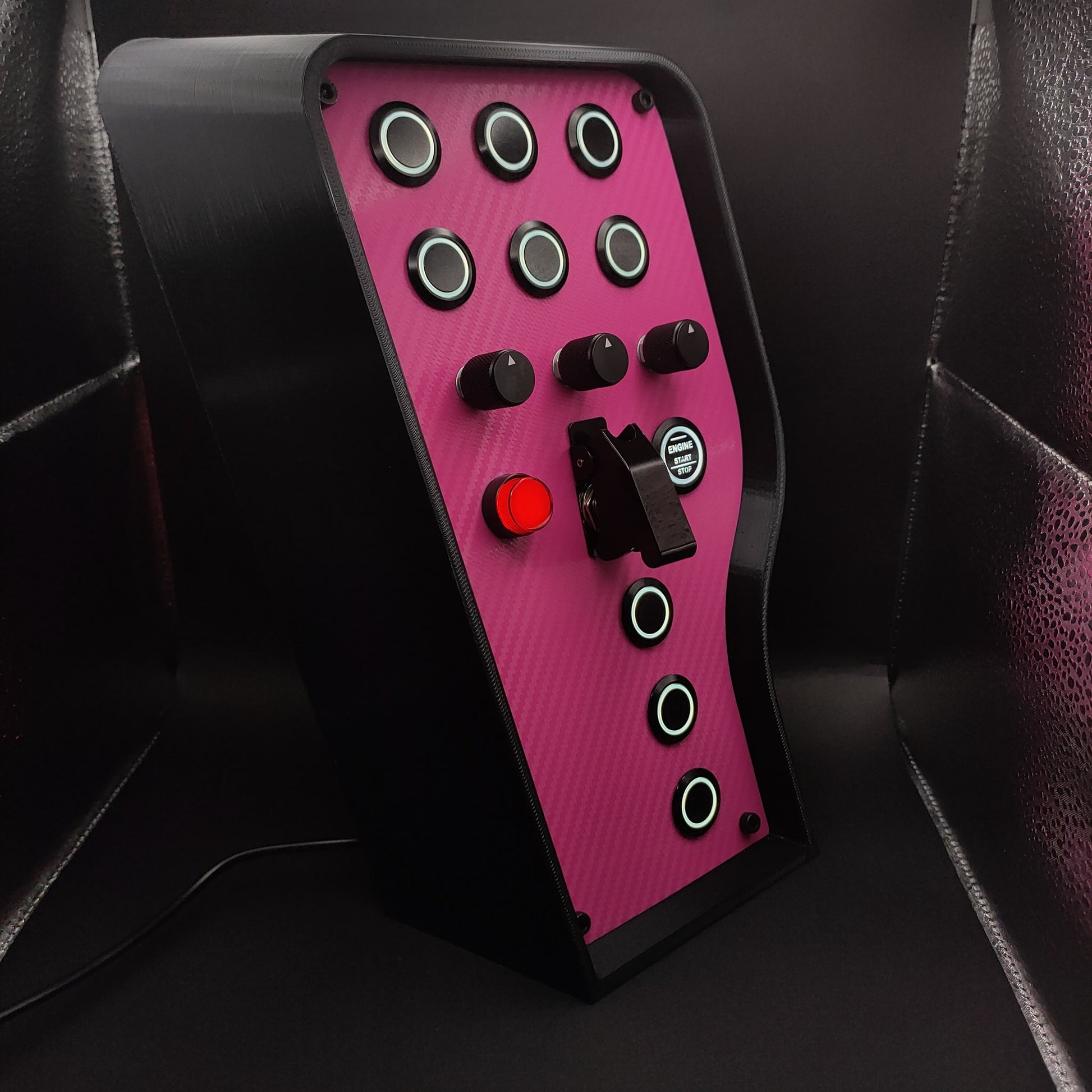 Right angle view of the Pink Edition showing the pink carbon fibre weave and black aluminium illuminated buttons.