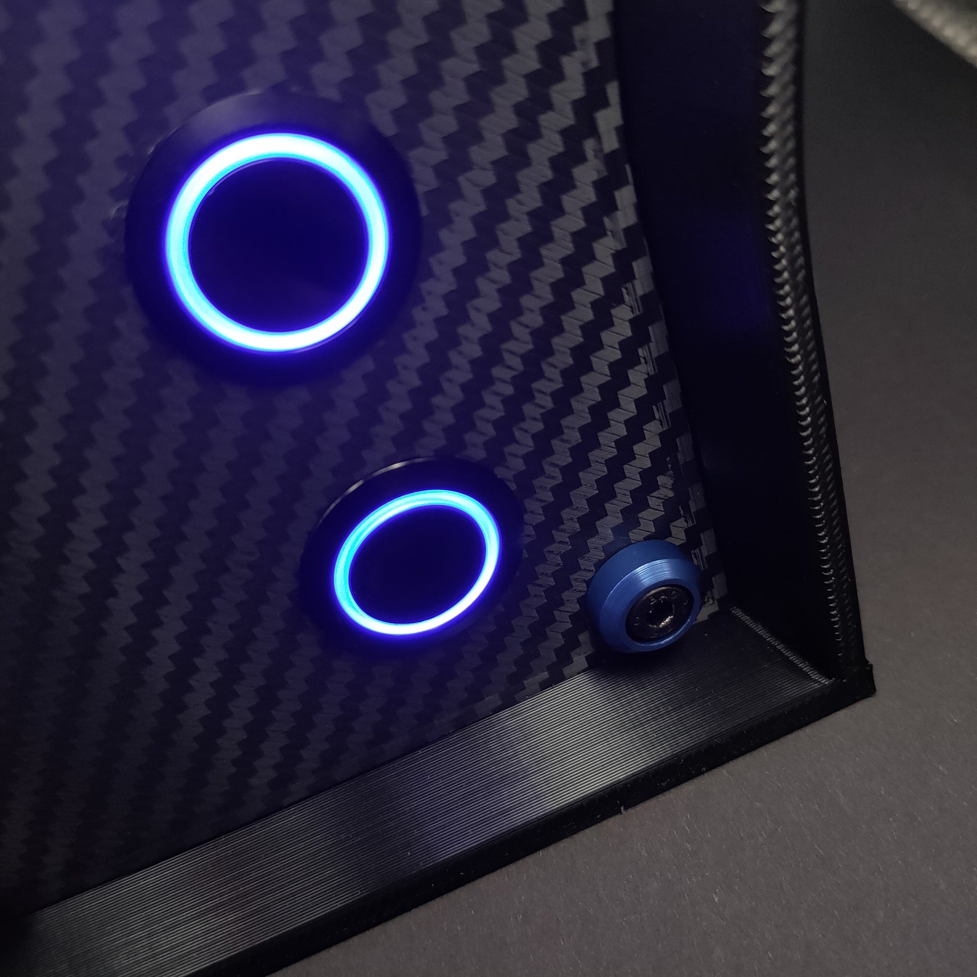 Detail shot of blue anodised aluminium bolt trim and blue LED illuminated momentary push buttons.