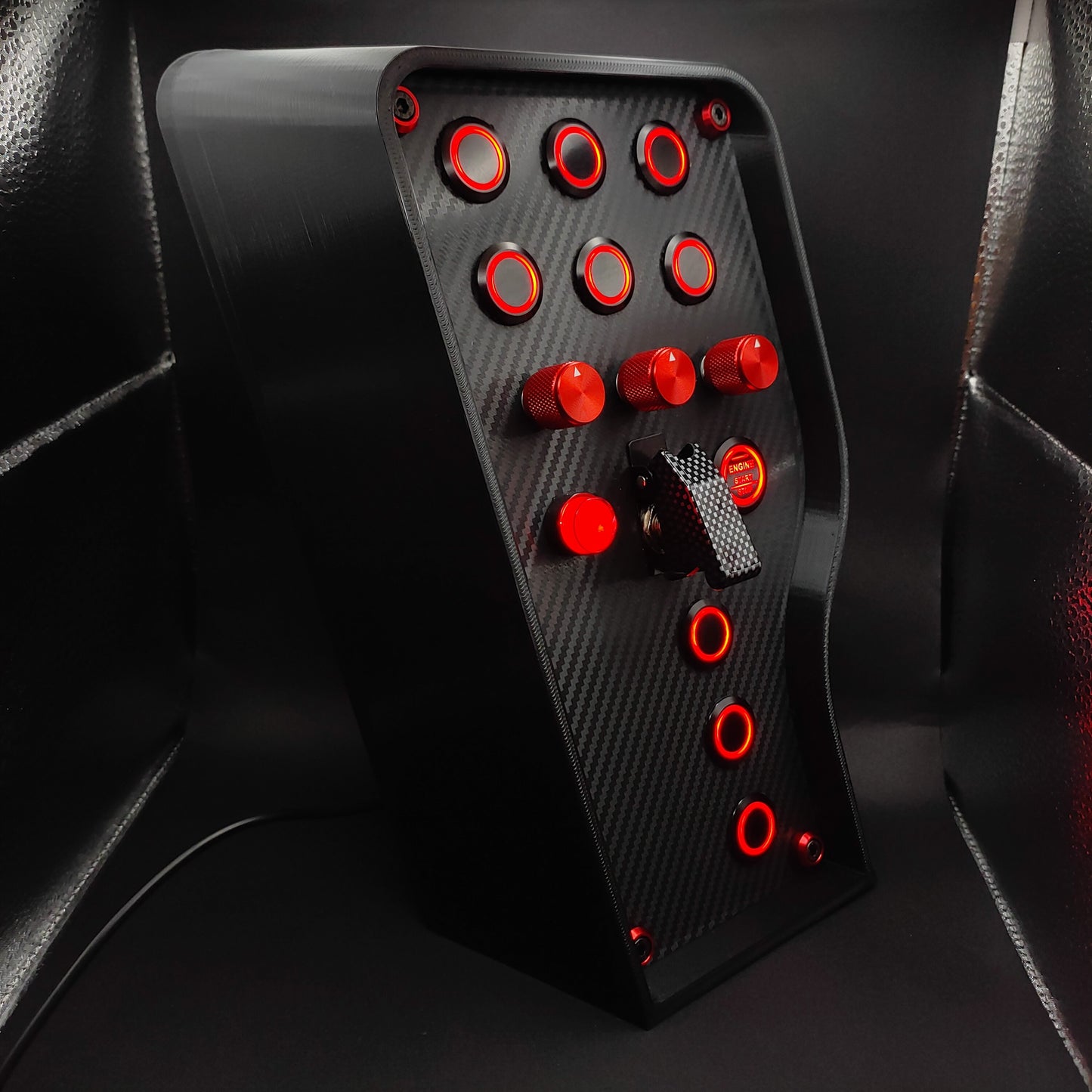 Right angle view of Sport+ Red Edition highlighting carbon fibre finish and red illuminated buttons.