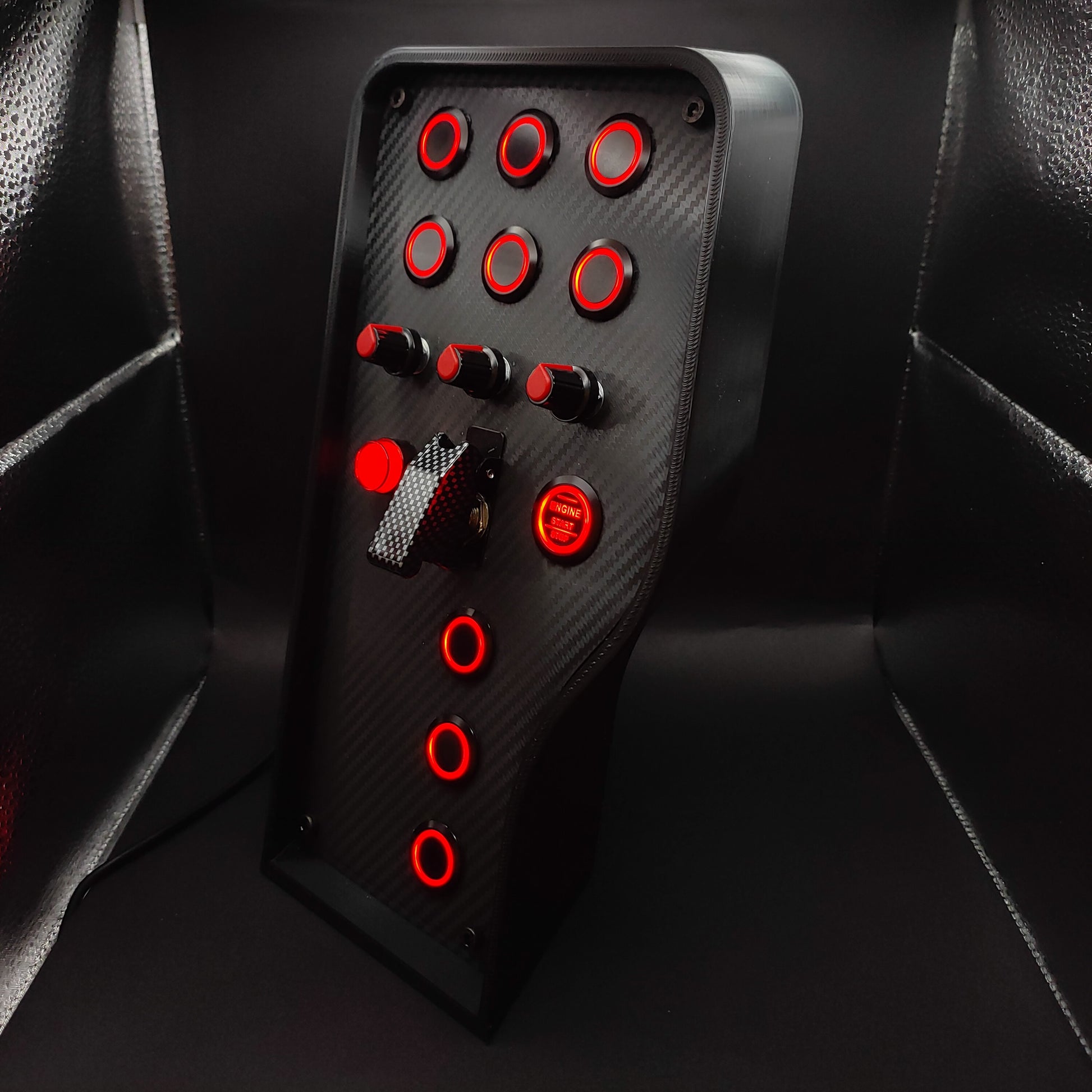 Left perspective of Sport Red button box showing black high-grip rotary encoders and carbon fibre finish.