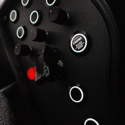 Close-up of black machined aluminium rotary encoders and white LED start button on the Stealth box.
