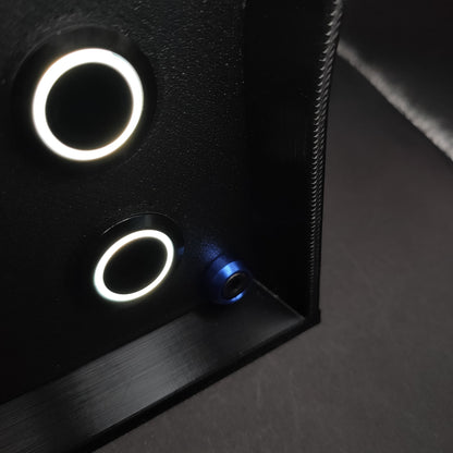 Detail shot of premium blue anodised aluminium bolt trim on a matte black sim racing button box.