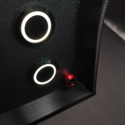 Detail shot of premium red anodised aluminium bolt trim on a matte black sim racing button box.